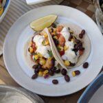 shrimp taco with grilled corn and black bean salsa and lime cilantro sauce